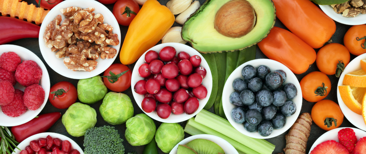 A table with a selection of colourful fruit and vegetables.