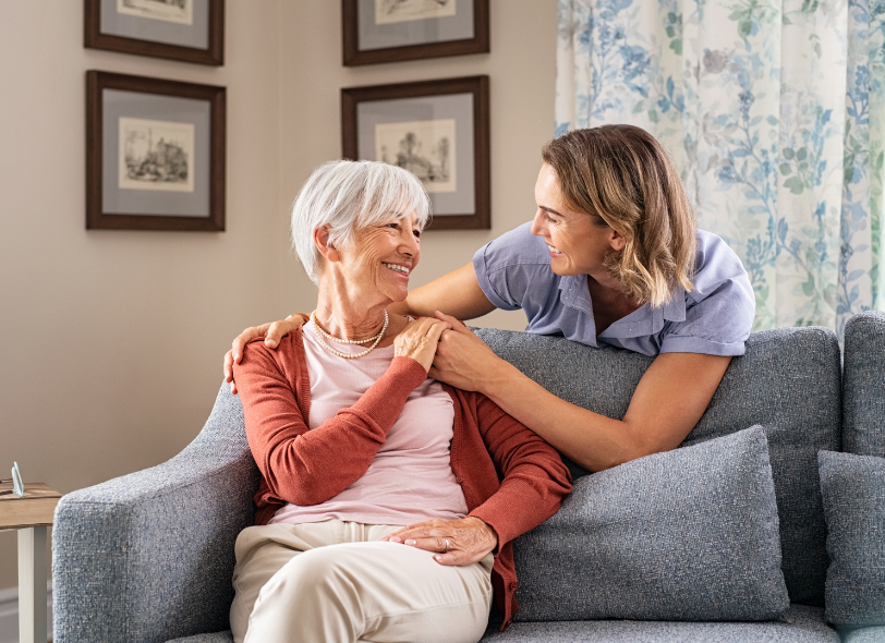 Adult daughter having a supportive conversation with her elderly mother about receiving support at home and maintaining independence as she is worried her elderly parent can no longer live alone.